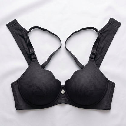 Black wireless underwire bra with textured cups and adjustable shoulder straps, laid flat on a white background.