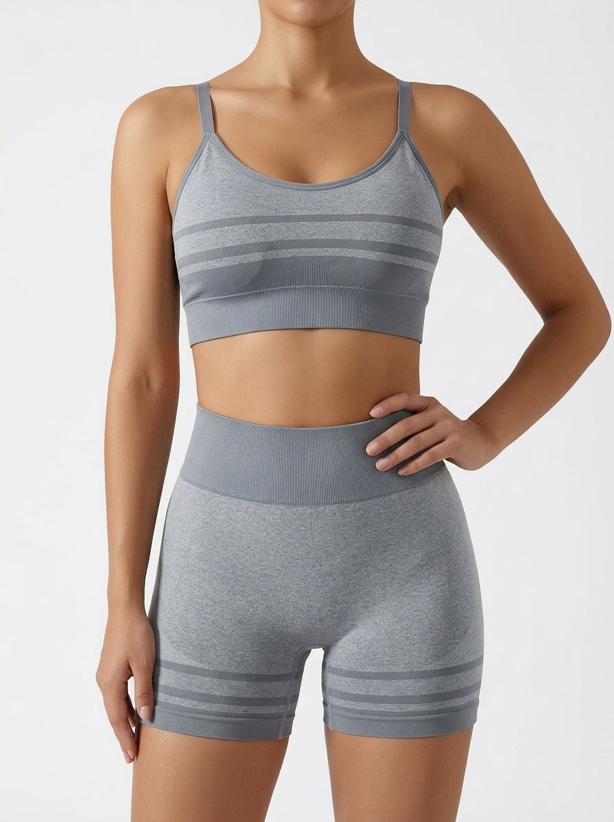 Yoga set for women featuring a seamless striped sports bra and high-waist shorts in gray.