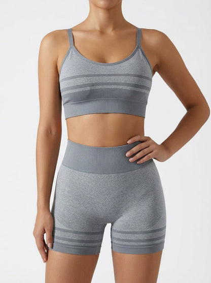 Yoga set for women featuring a seamless striped sports bra and high-waist shorts in gray.