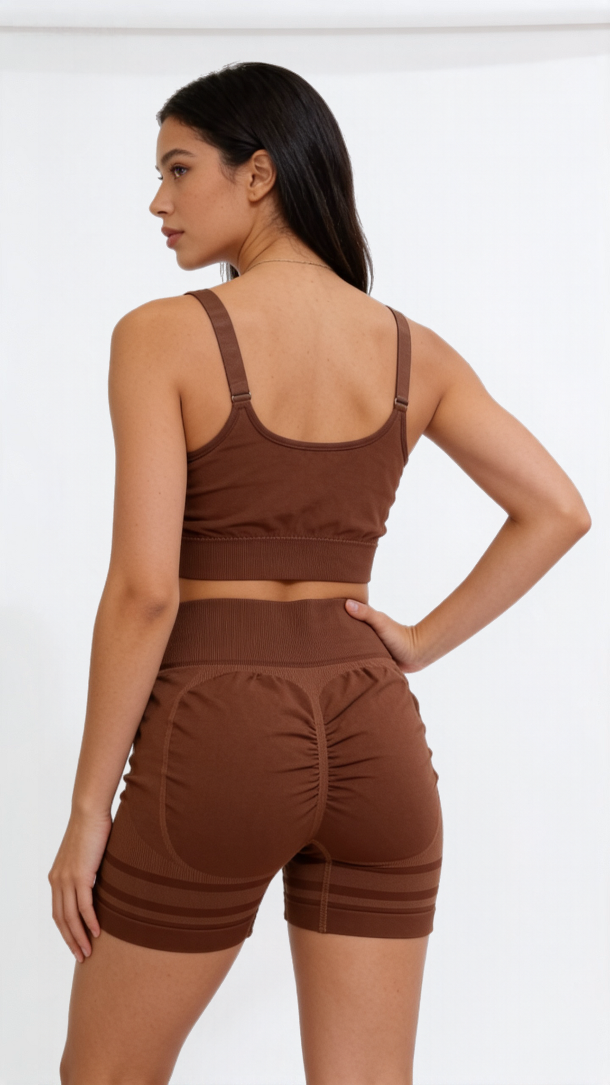 Yoga set for women featuring a brown seamless sports bra and high-waist scrunch shorts from the Nudra Seamless Collection.